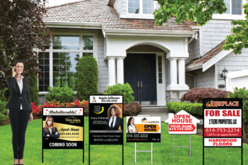 Real estate agent standing in front of a home with multiple branded yard signs, representing real estate marketing and signage options.