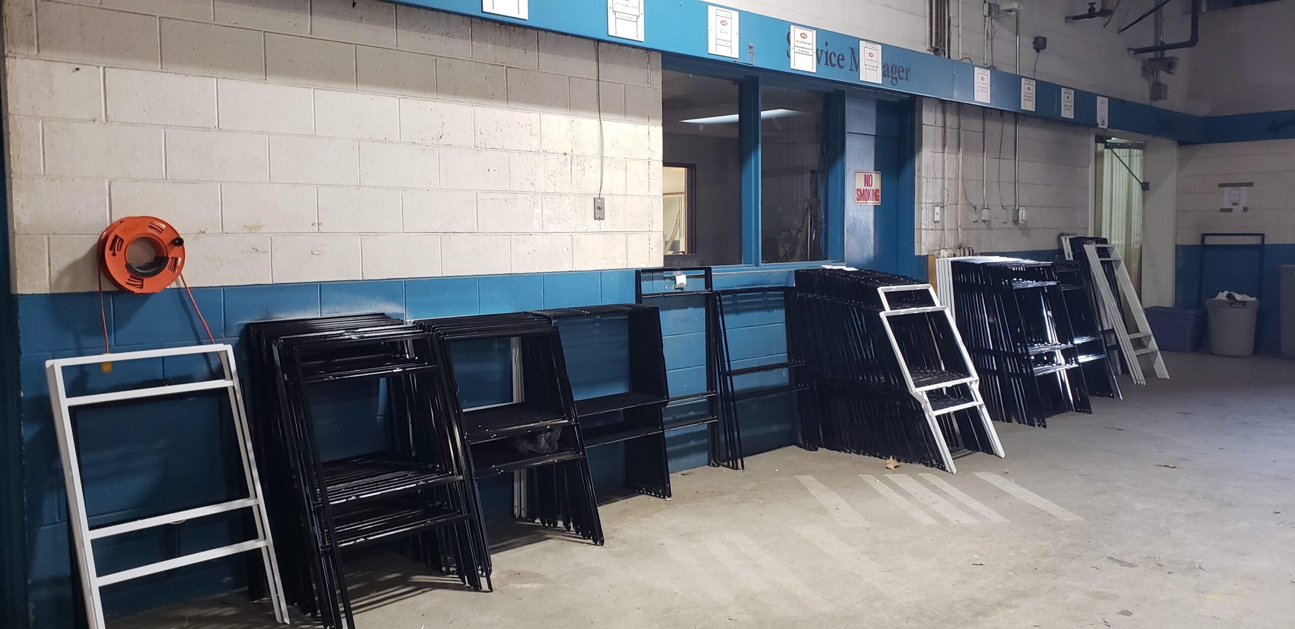 Organized sign frames staged in a production facility to meet fabrication and compliance standards.