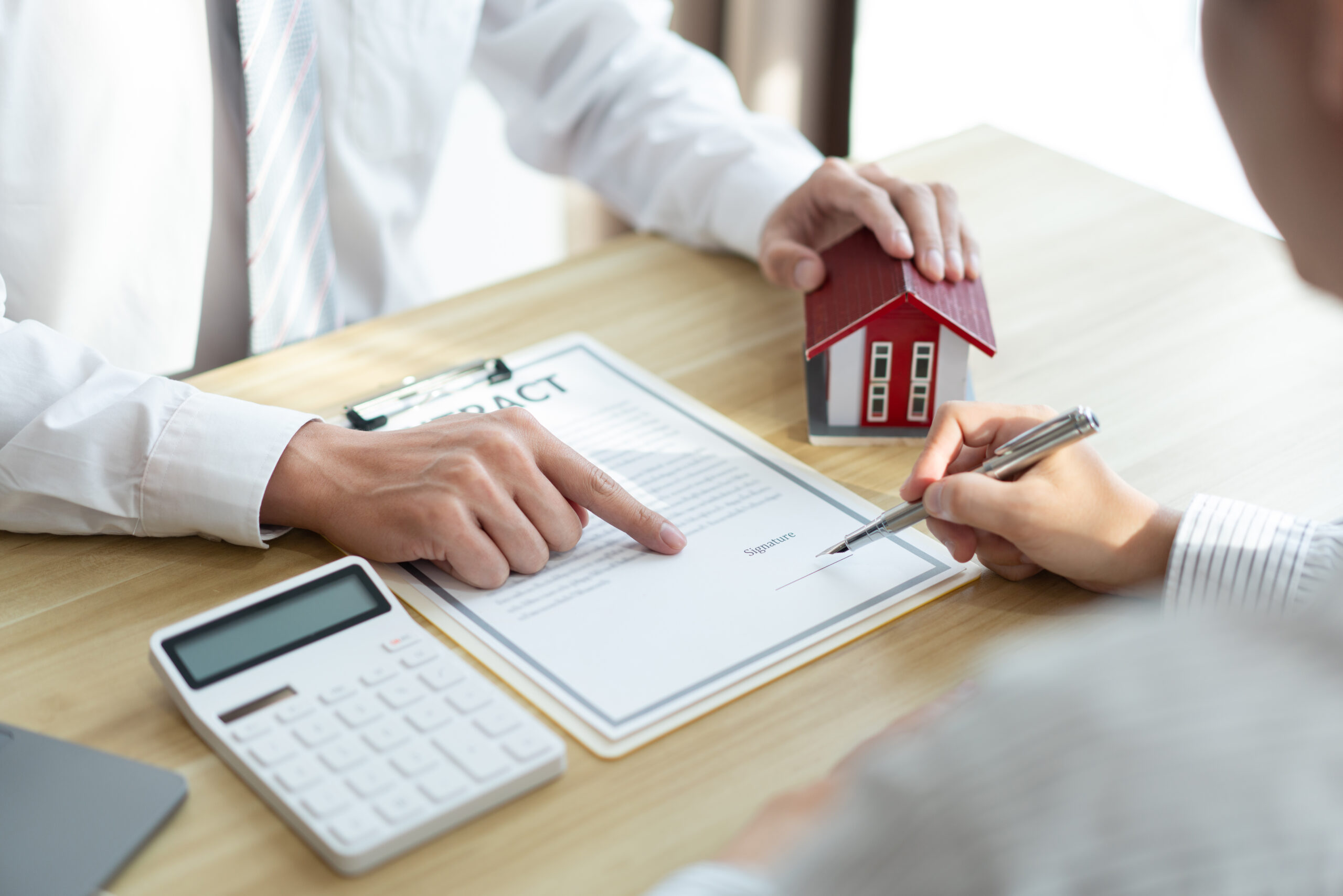 Real estate agent reviewing a contract with a client, emphasizing transparency, accuracy, and informed decision-making