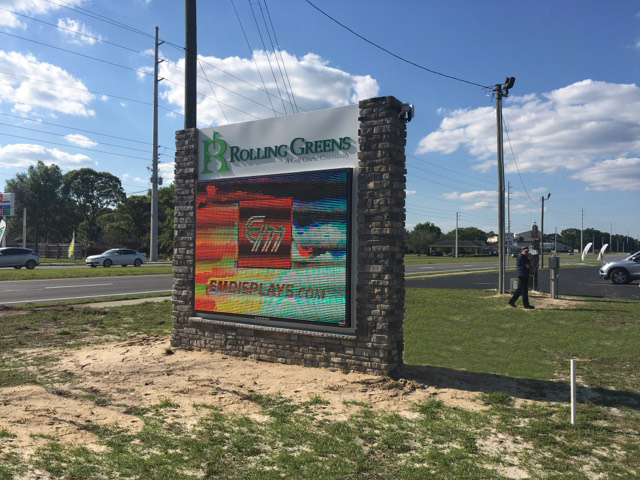 Electronic message center monument sign installed with stone structure and digital display