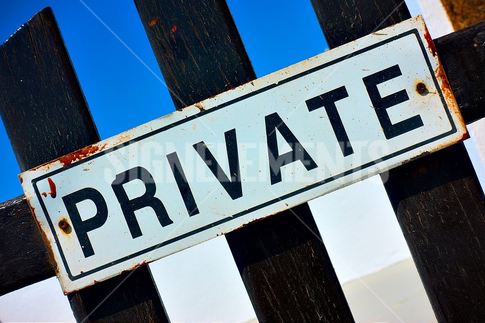 Rusted metal sign showing long-term exposure to moisture and outdoor weather conditions