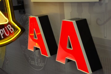 Reverse lit LED channel letters mounted on interior wall creating halo illumination effect.