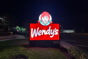 Modern LED illuminated monument sign installed at commercial property, brightly lit at night for enhanced visibility.