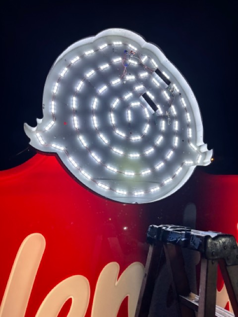 Interior of modern LED illuminated cabinet sign showing module layout and low-voltage lighting system.