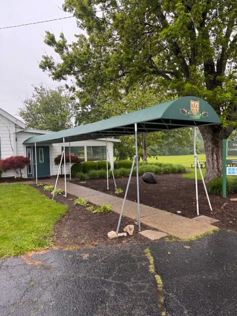 Decorative fabric awning creating a covered walkway and sheltered entrance for a commercial building