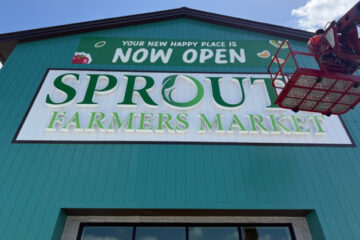 Exterior wall sign installed on a commercial retail building, showing permanent building-mounted signage