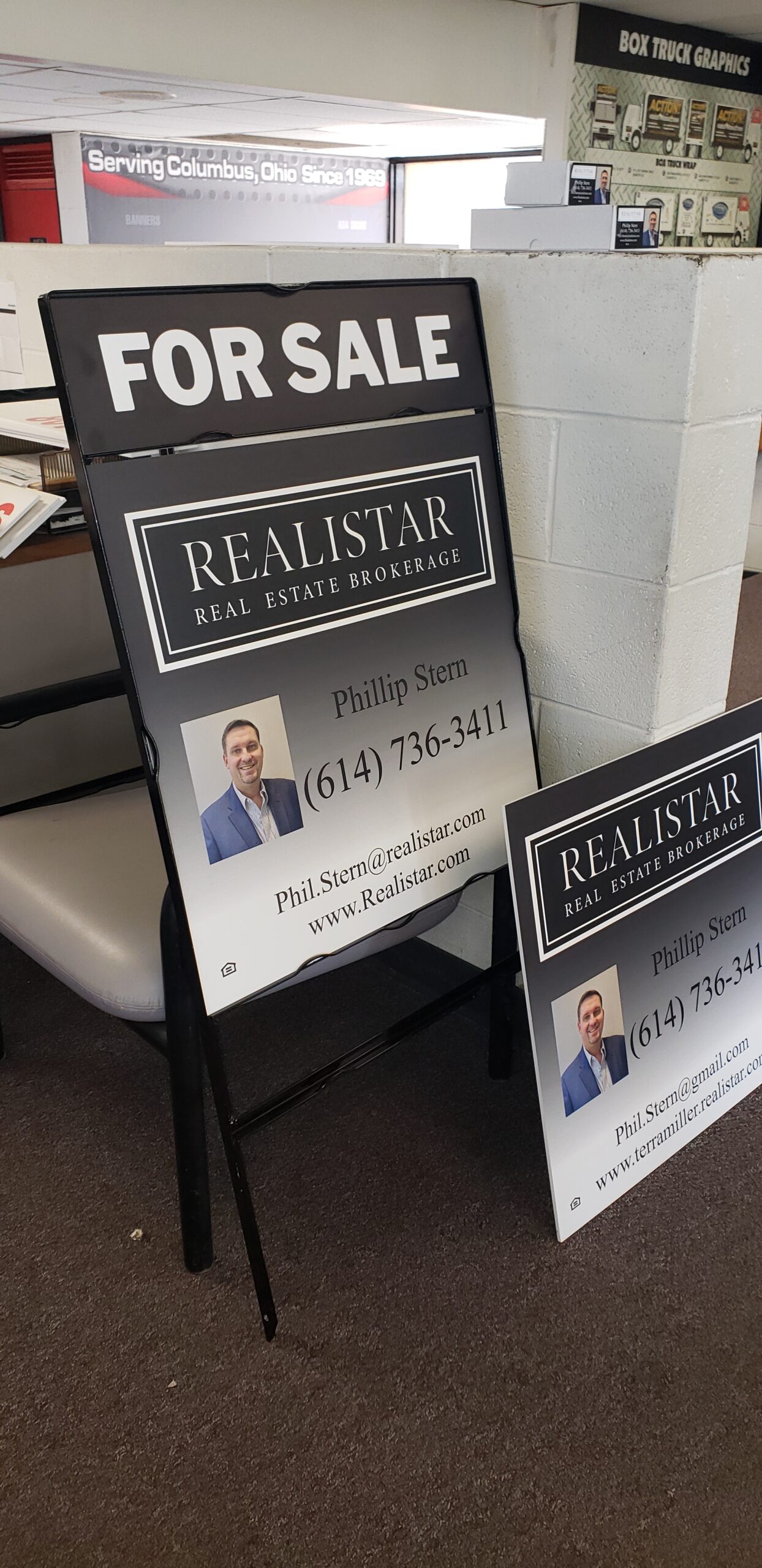 Finished Realistar real estate sign panel and frame displayed inside the Custom Sign Center showroom after production and assembly.