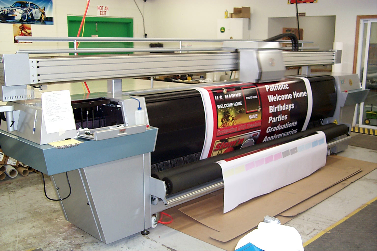 Large-format printer producing full-color custom signage during the commercial sign production process.